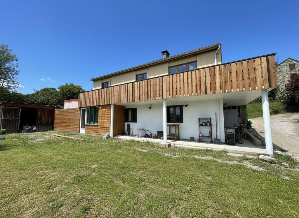 a house with a deck on top of it at T4 avec jardin - ENVEITG in Enveitg