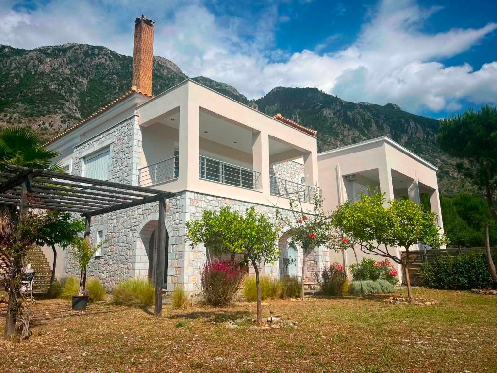 a large house with a mountain in the background at Sea and Mountain View in Kalamata