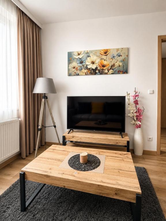 a living room with a coffee table and a painting at Apartmány U Jelena 2 in Český Krumlov