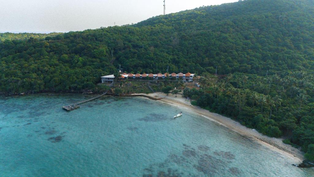 an aerial view of a house on an island in the water at Legon Waru Cottage in Karimunjawa