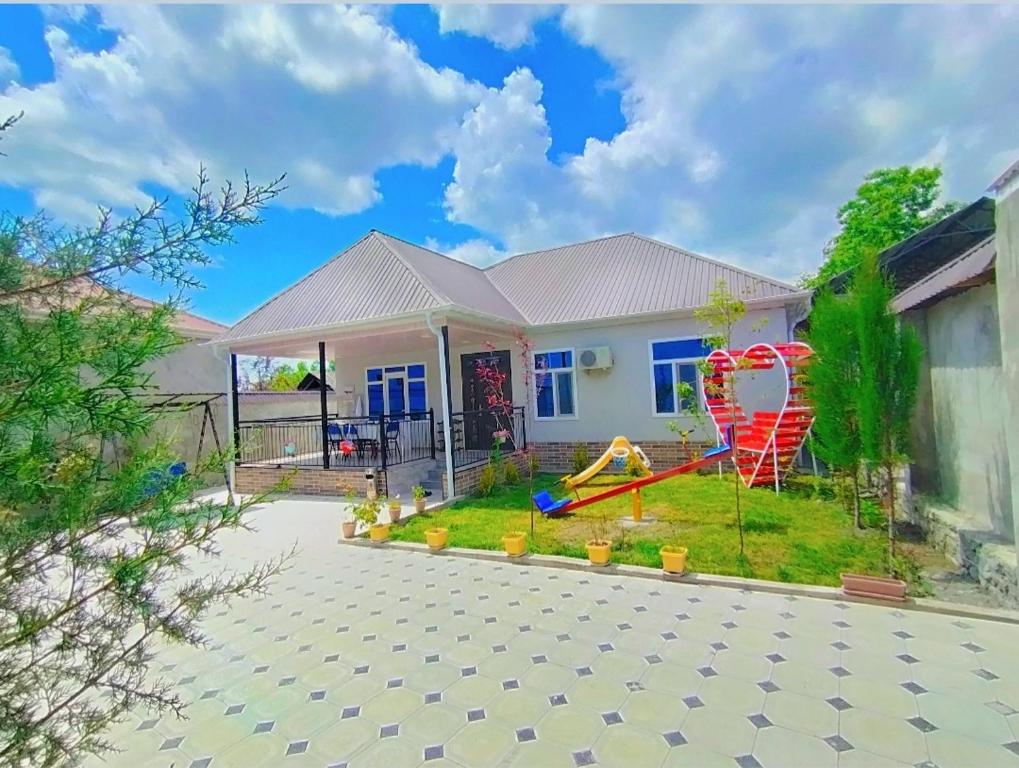 a house with a playground in the yard at Qəbələhouse in Gabala