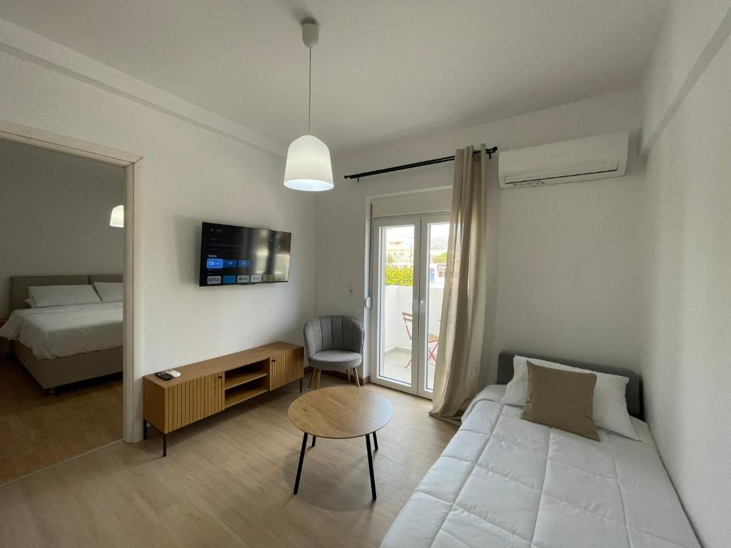 a living room with a bed and a couch at MyLiving in Kardamaina