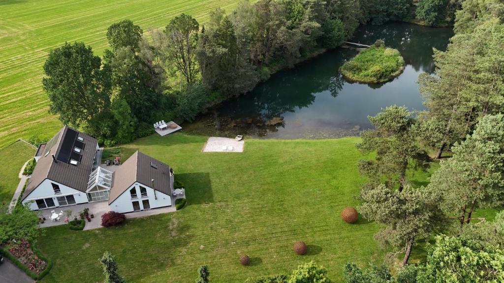 an aerial view of a house next to a lake at Kromven in Merksplas