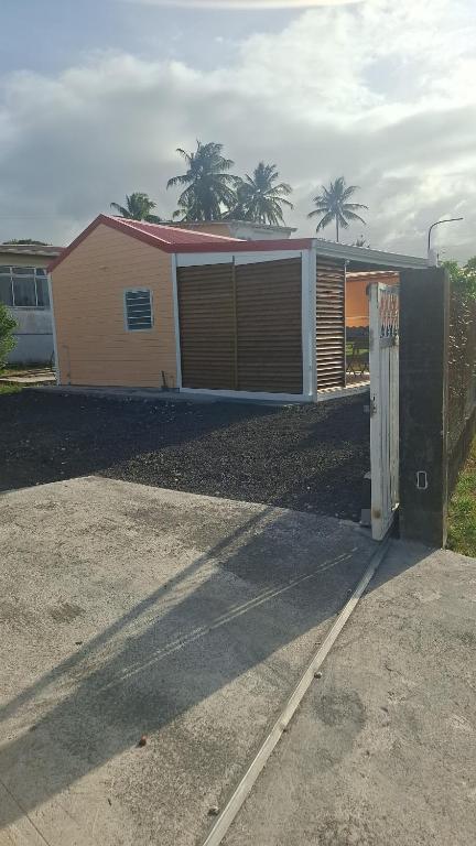 a house with a gate in a driveway at bungalow détente in Capesterre-Belle-Eau