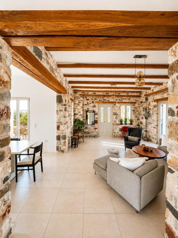 a large living room with a stone wall at Aphrodite's Villa in Ambelas