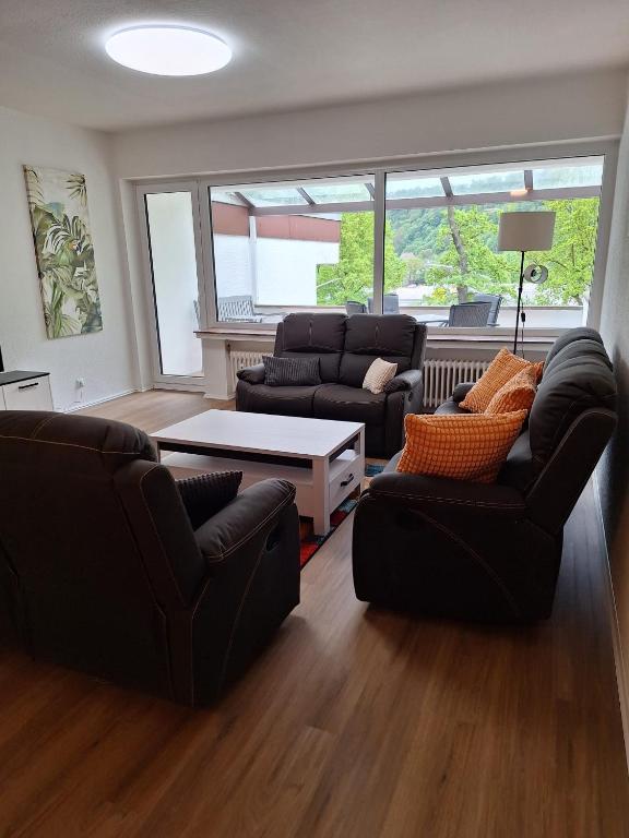 a living room with two couches and a table at Ferienwohnung Bever in Bad Karlshafen