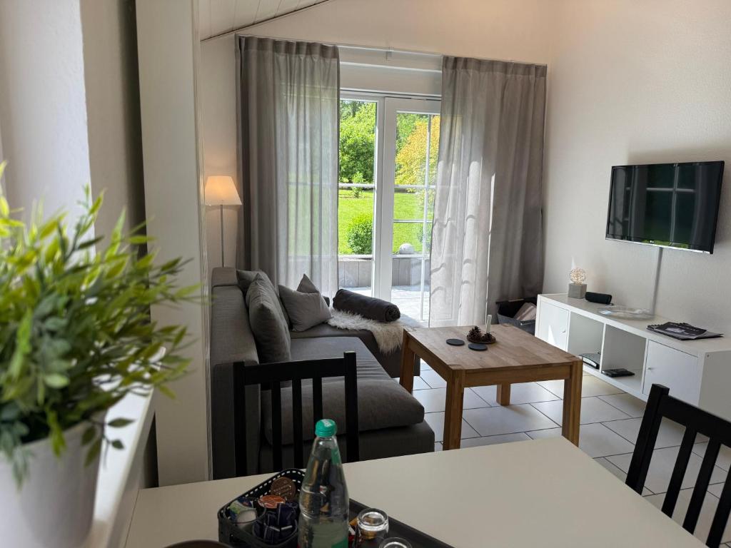 a living room with a couch and a table at Ferienhaus Burbach in Burbach