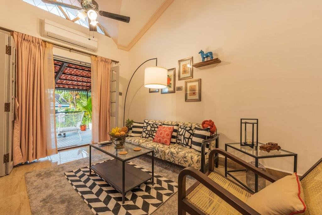 a living room with a couch and a table at Luxury 2BHK Villa Near Anjuna Beach, North Goa in Anjuna