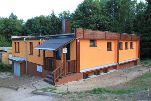 a building with an orangeructure with a porch at Pastvinka in Pastviny