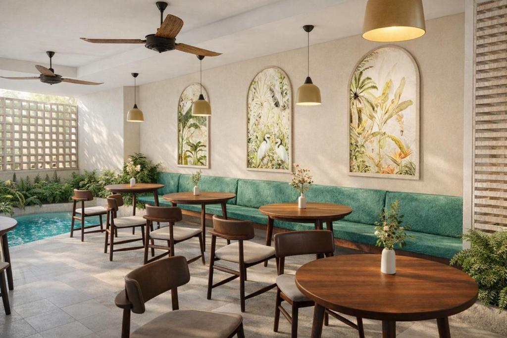 a restaurant with tables and chairs and a pool at SUWA CHANDU - By Mountain Boutiques Luxury Collection in Mirissa