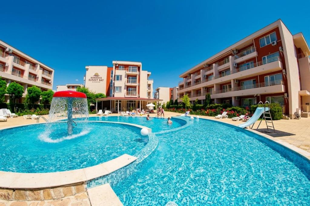 a pool with a fountain in the middle of a building at Summer Dream, Nesebar Fort Club, Sunny Beach in Sunny Beach