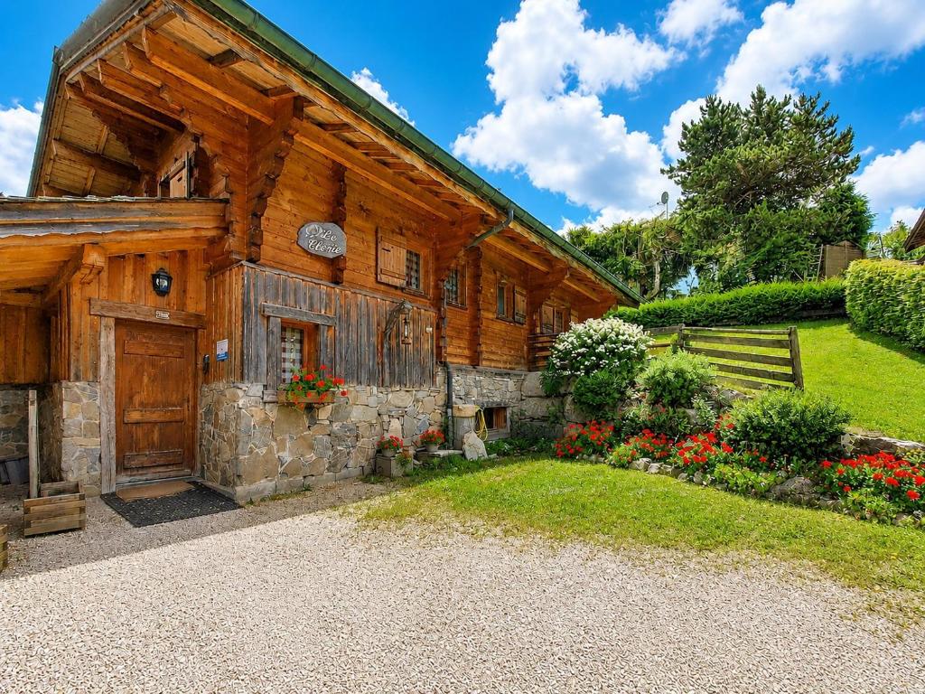 a large wooden house with a garden in front of it at Clevie in Morzine