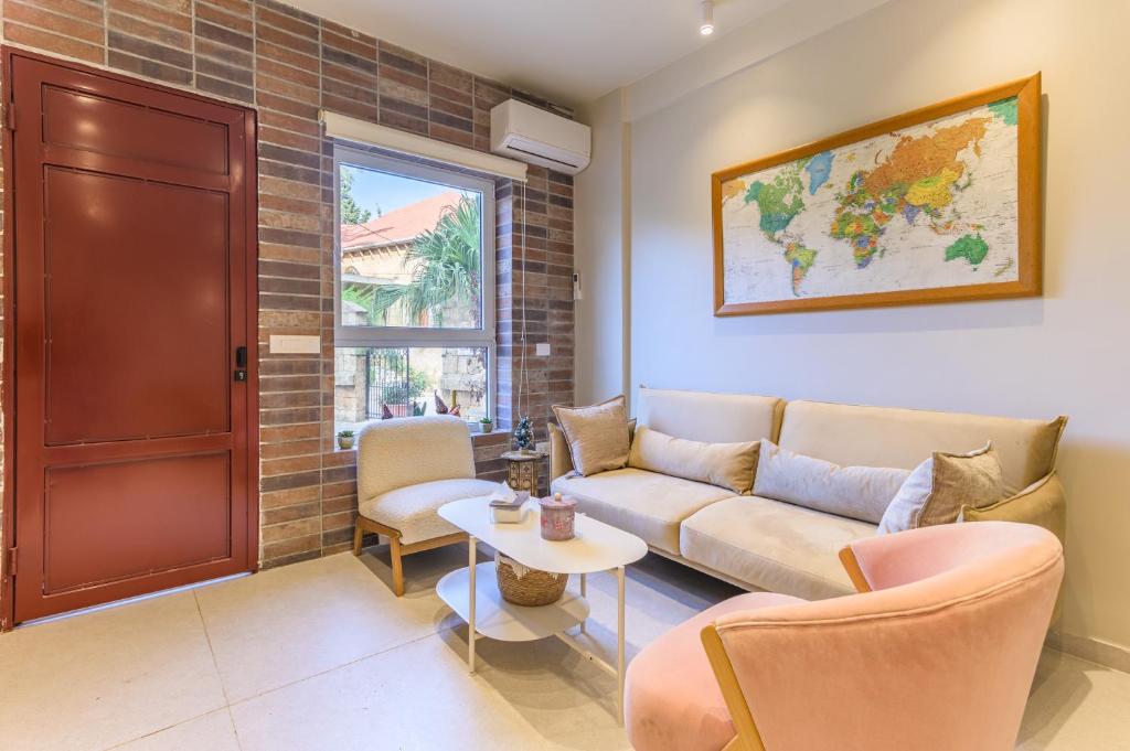 a living room with a couch and a table at Happy Cactus 1BR Apartment In Batroun Souks in Batroûn