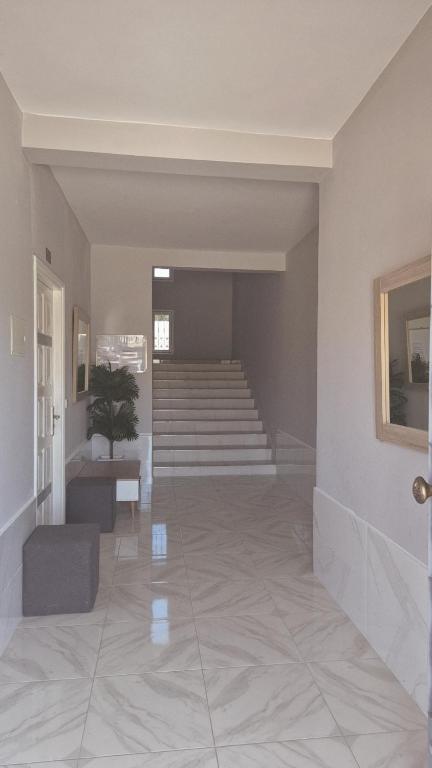 a hallway with stairs and a potted plant in it at Sidi Kankouch Bay in Tangier