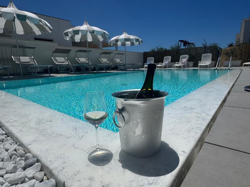 a bottle of wine in a bucket next to a wine glass at Vistamare - Bed & Breakfast in Alliste