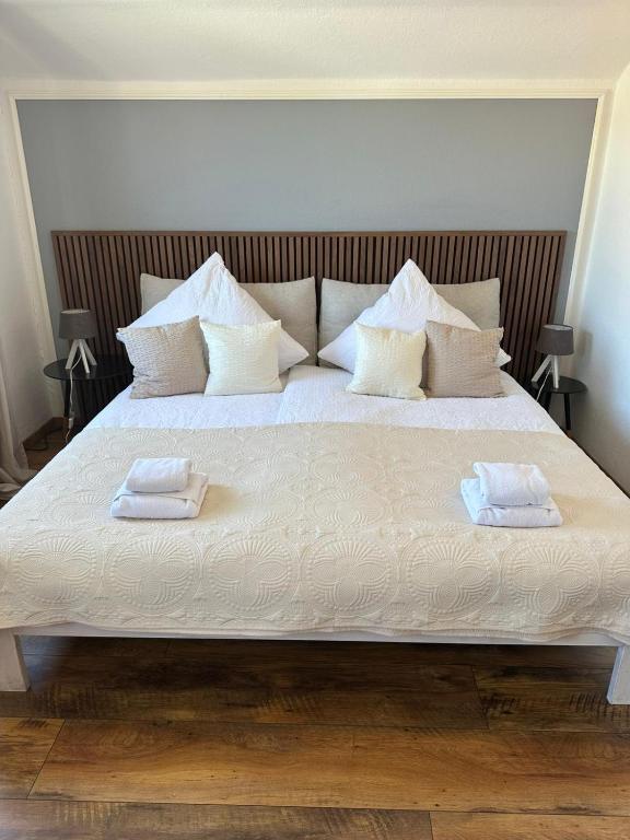 a large white bed with two towels on it at Daddy's home in Hargesheim