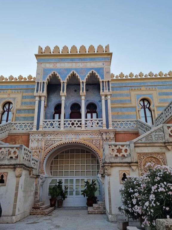 an ornate building with a balcony on top of it at Le 2 vele in Cerfignano