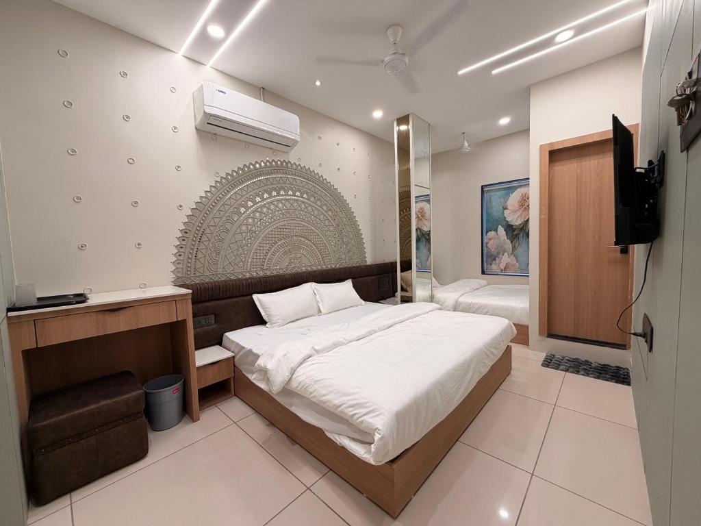 a bedroom with a bed and a television in it at Hotel Shree Maya Comfort Inn in Ujjain