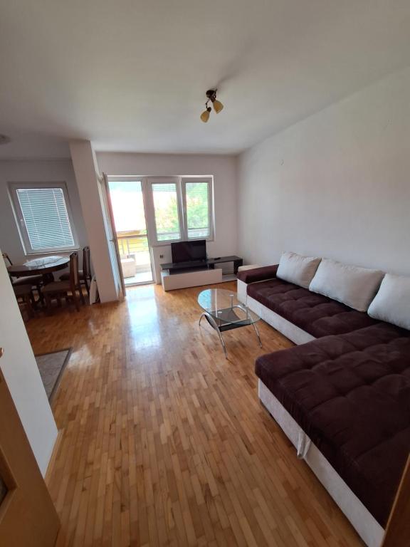 a living room with a couch and a table at Stan Foča in Foča
