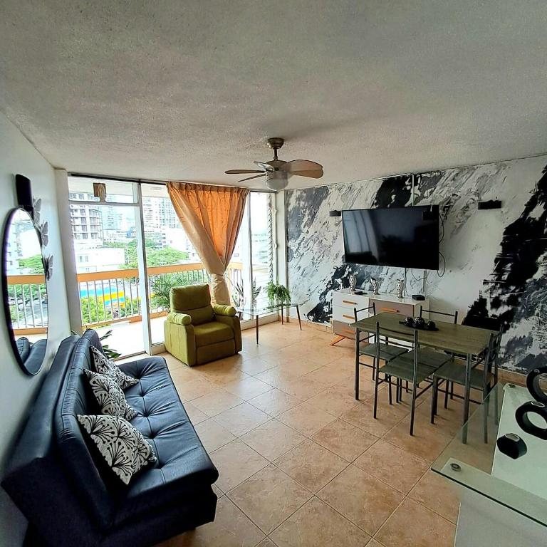 a living room with a couch and a table at Troya 701 in Gaira