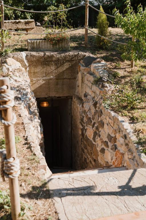 a stone tunnel with a door in the ground at Le Bunker Secret - Logement Insolite in Florensac