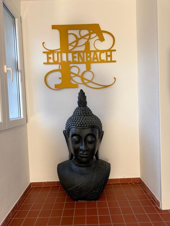 a statue in a room with a sign on a wall at Bartenwetzer Schleusenhaus 1 in Melsungen