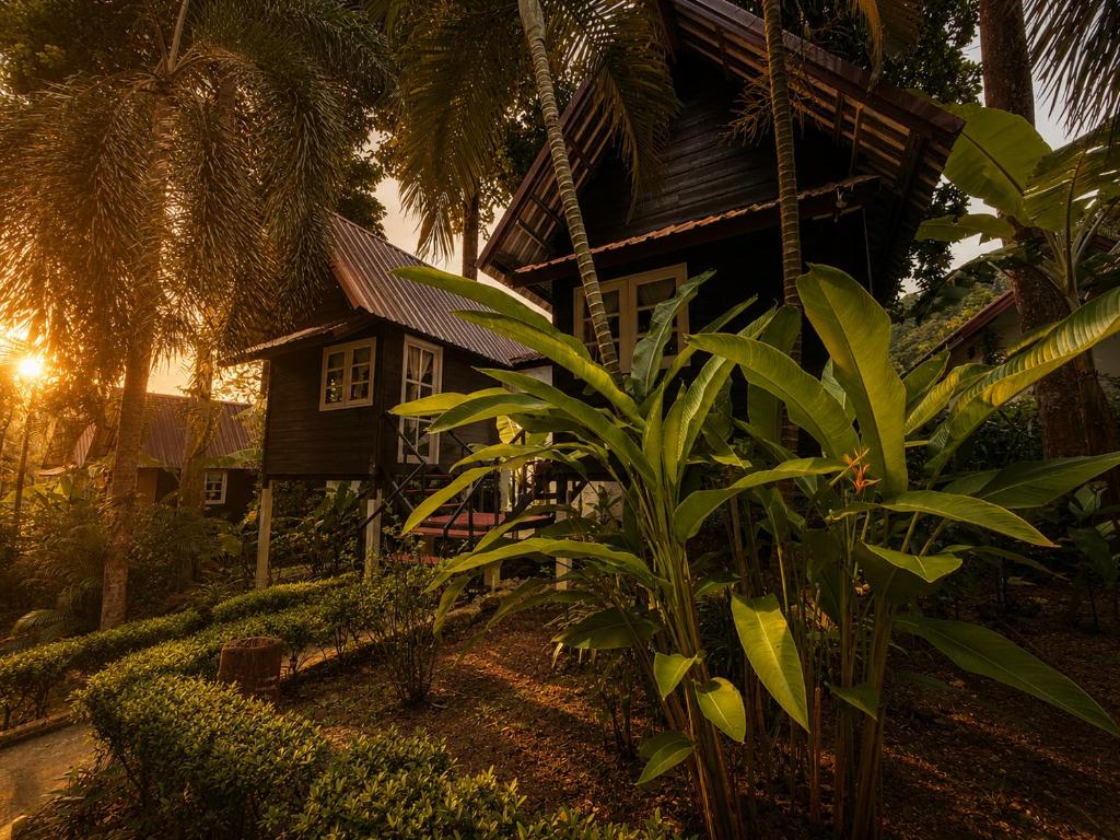 a house with a palm tree in front of it at Vanara Resort in Ko Chang