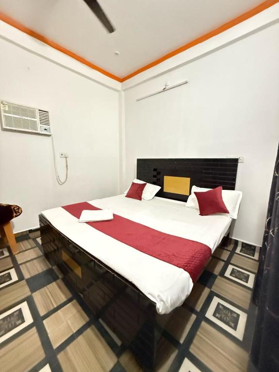 a bedroom with a large bed in a room at Shri Raghuveer guest house in Ayodhya