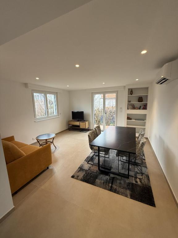 a living room with a table and a couch at Cozy apartment in Vendenheim in Vendenheim