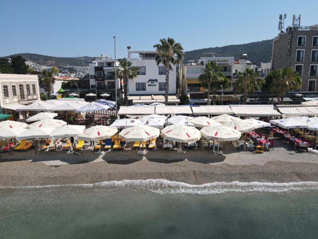an aerial view of a beach with umbrellas at Artemis Hotel in Bodrum City
