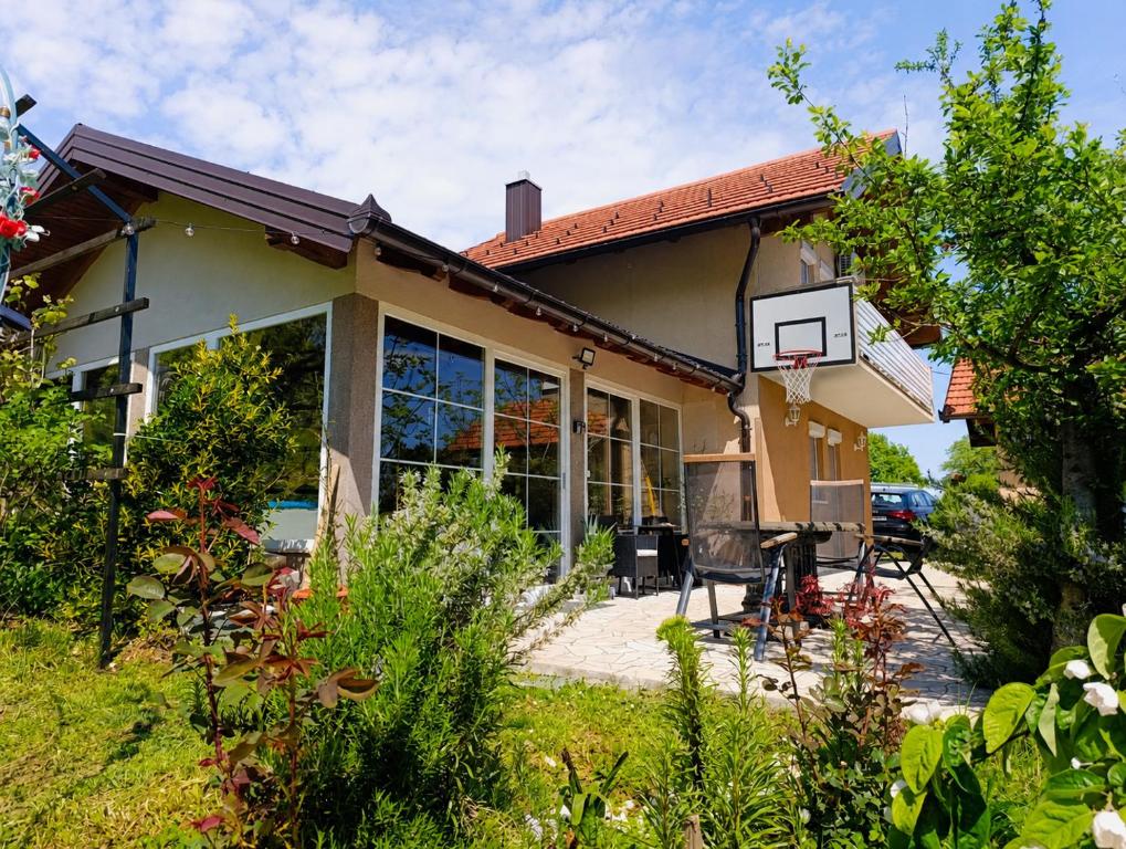 a house with a basketball hoop in the yard at VA vikendica Tesanj in Tešanj