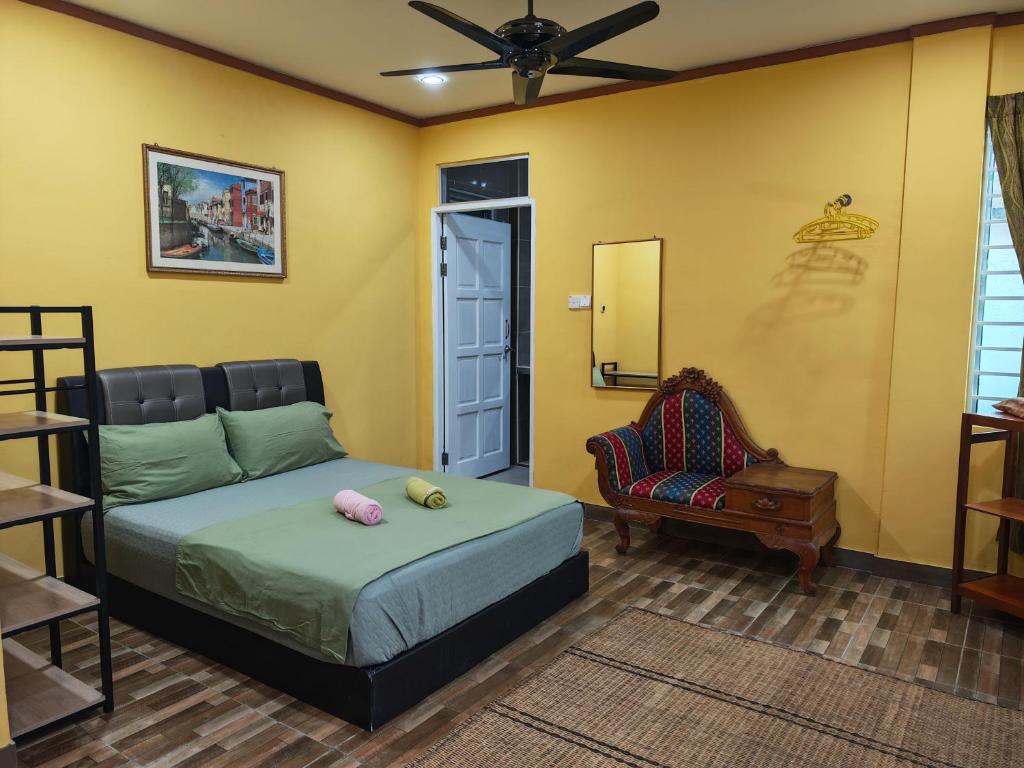 a bedroom with a bed and a chair at Jazepuri - Jaze 1 in Kuching
