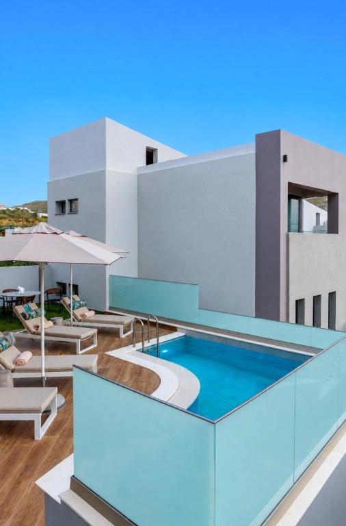 a swimming pool on the side of a building at Plakias Galaxy Villas in Plakias