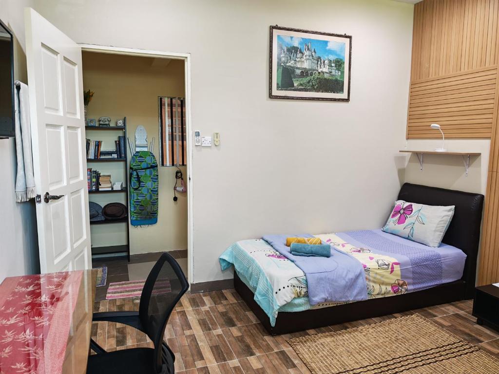 a small bedroom with a bed and a table at Jazepuri - Jaze 2 in Kuching