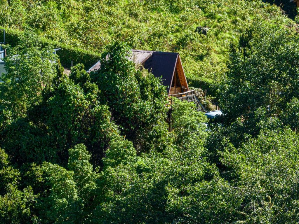 a house in the middle of a hill with trees at Jaulares Glamping in Alaska