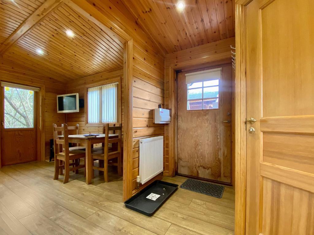a wooden room with a table and a dining room at Pine Lodge - Uk46279 in Camerton