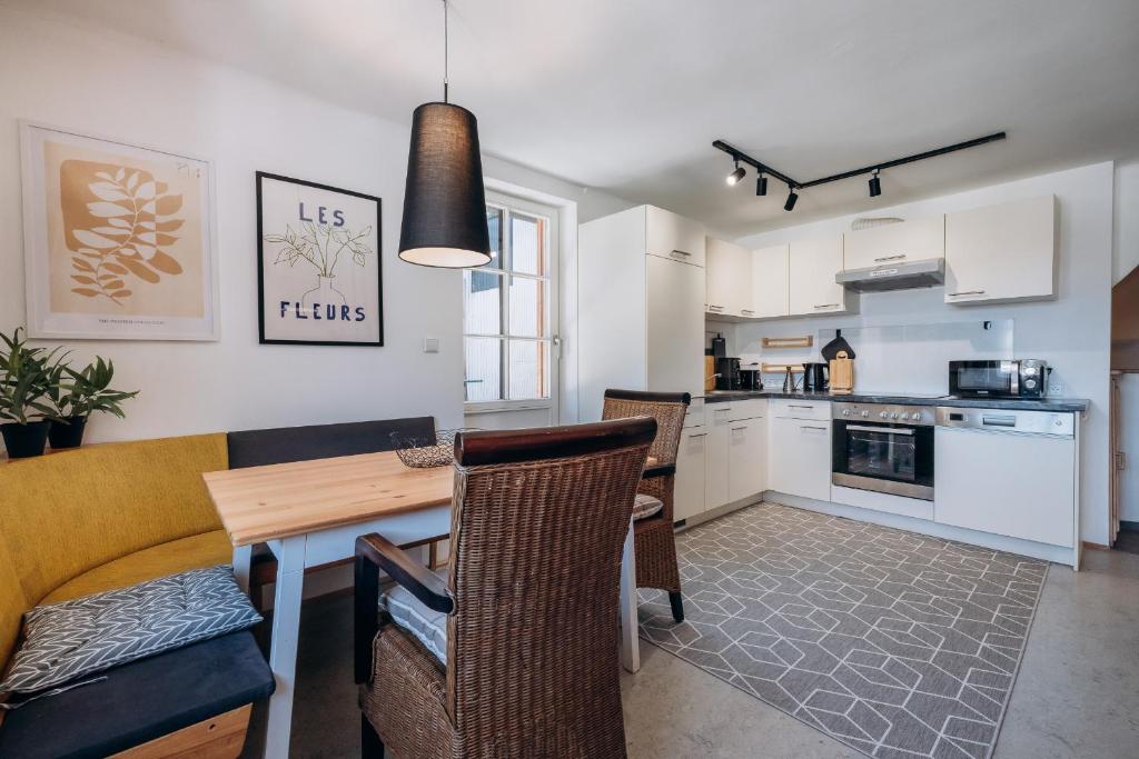 a kitchen and dining room with a table and chairs at KUL App 5 by Alpenidyll Apartments in Öblarn