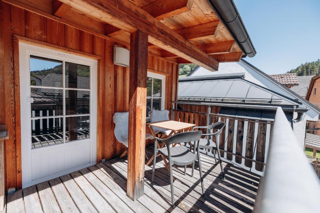 a wooden deck with a table and chairs on it at KUL App 6 by Alpenidyll Apartments in Öblarn