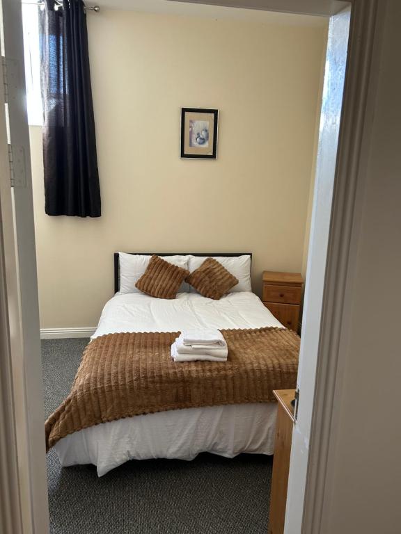 a bedroom with a bed with a brown blanket at The pillar in Wexford