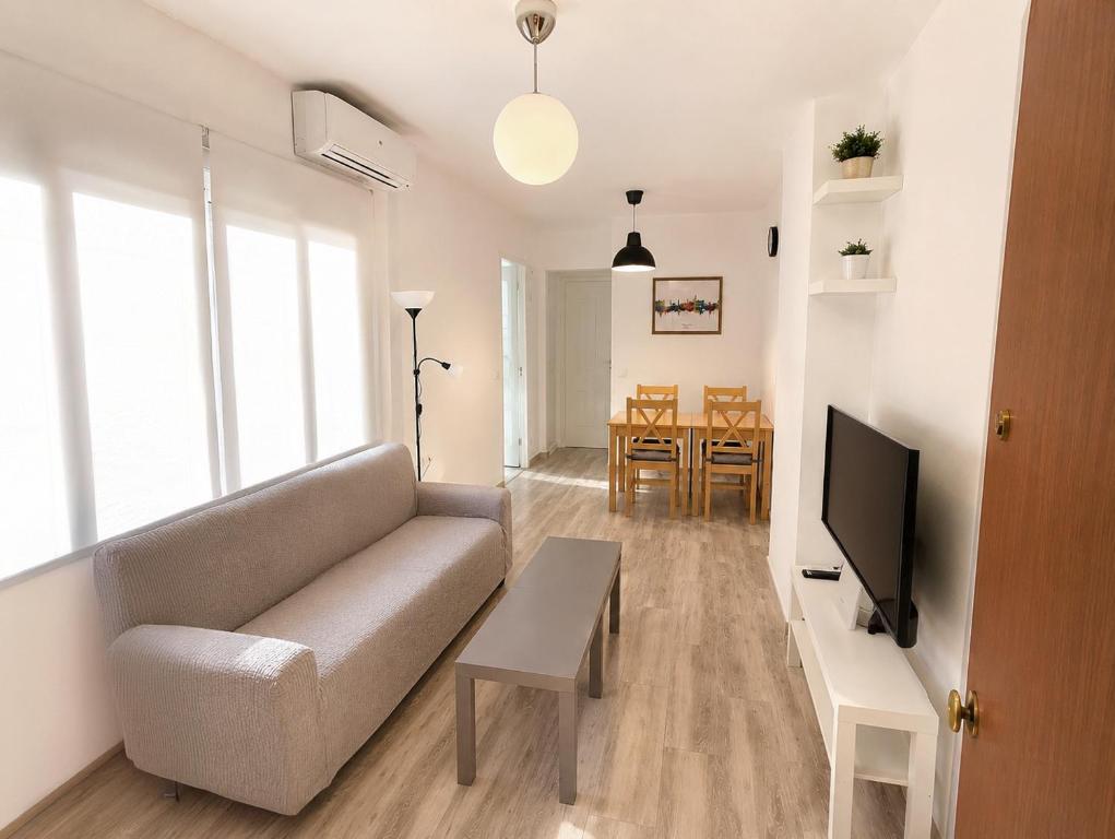 a living room with a couch and a table at Centre Sweet Home in Málaga