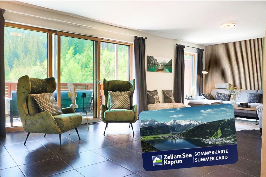 a living room with two chairs and a table at Apartment ZellPeak in Zell am See