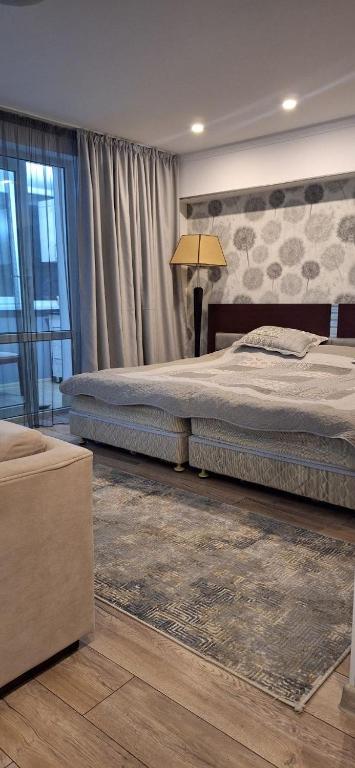 a bedroom with two beds and a lamp in it at Иссык-Куль in Tossor