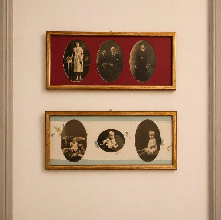 two framed pictures of people on a wall at Matteotti suite&gare in Asti