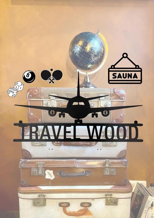 a stack of luggage with a globe on top at Travel Wood in Waulsort