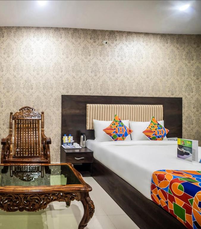 a bedroom with a large bed and a coffee table at Hotel Tirumala in Secunderabad