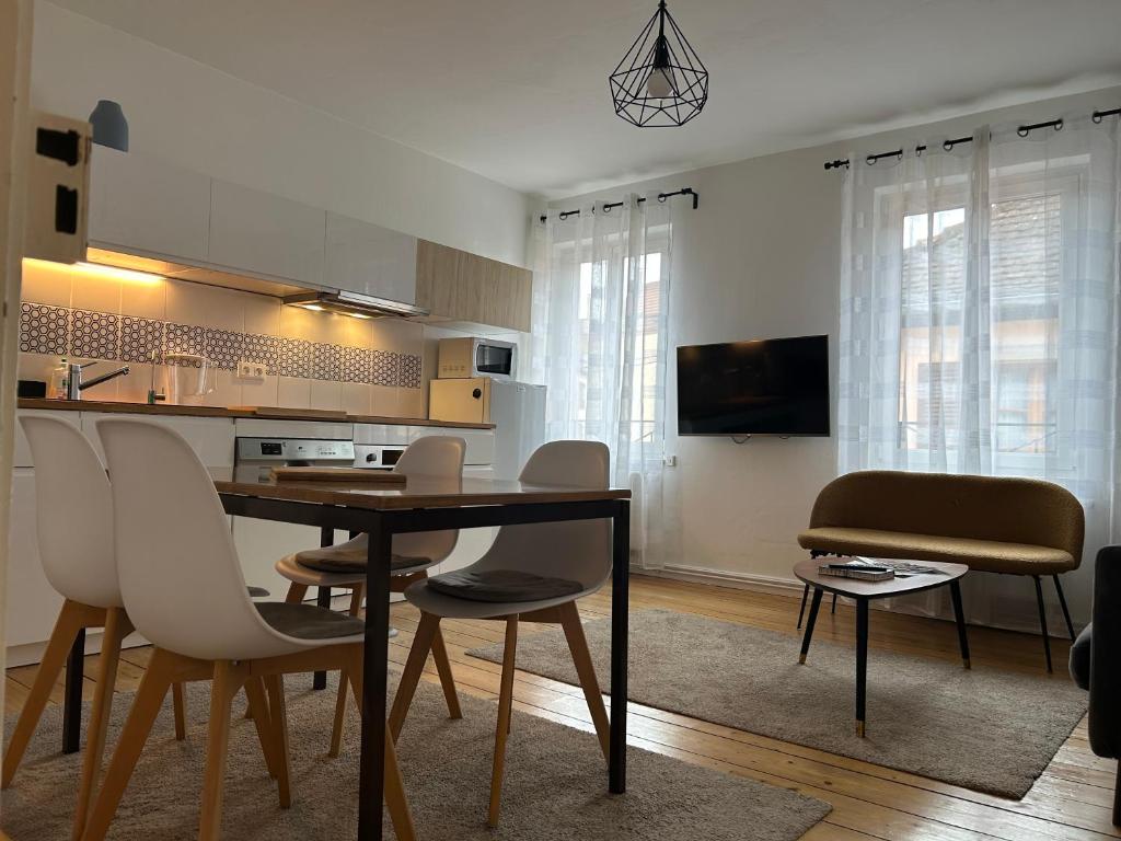 a kitchen and dining room with a table and chairs at BELISAMA in Molsheim