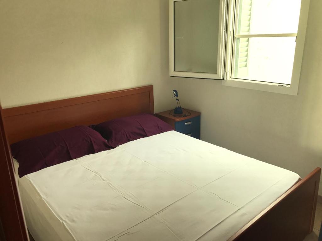 Säng eller sängar i ett rum på Camping Porto Miggiano