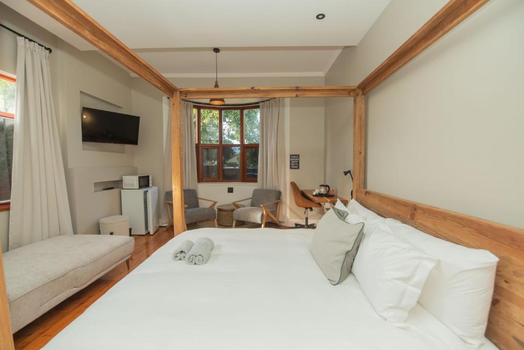 a bedroom with a large white bed in a room at The Valley Escape - Executive Suite in Gqeberha