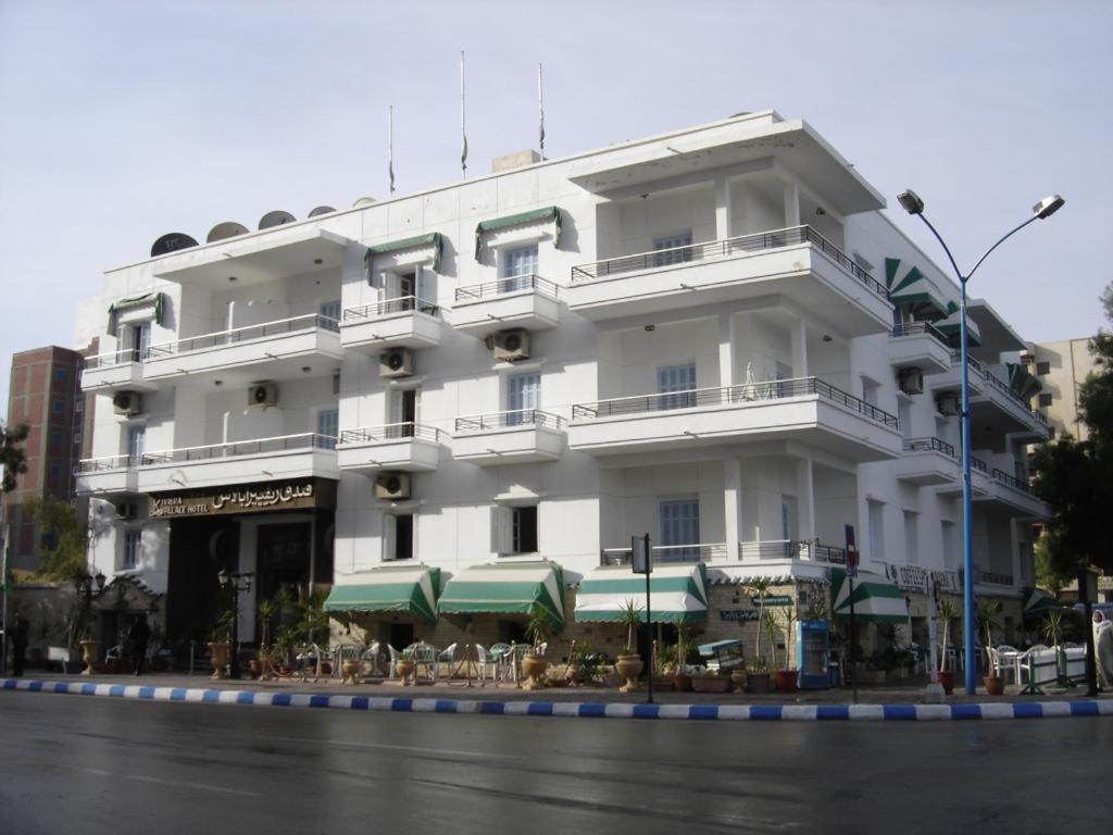 a large white building with tables in front of it at Revira Palace - Marsa Matrouh in Marsa Matruh
