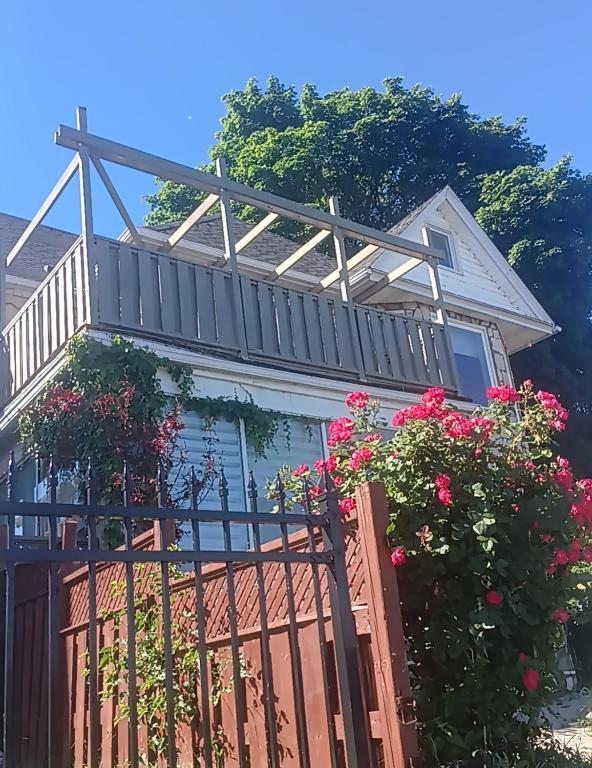 a pergola on top of a house with flowers at Waterfront Home Windsor ,On, Ca in Windsor